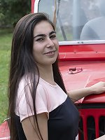 Paris poses naked outdoors by her red jeep